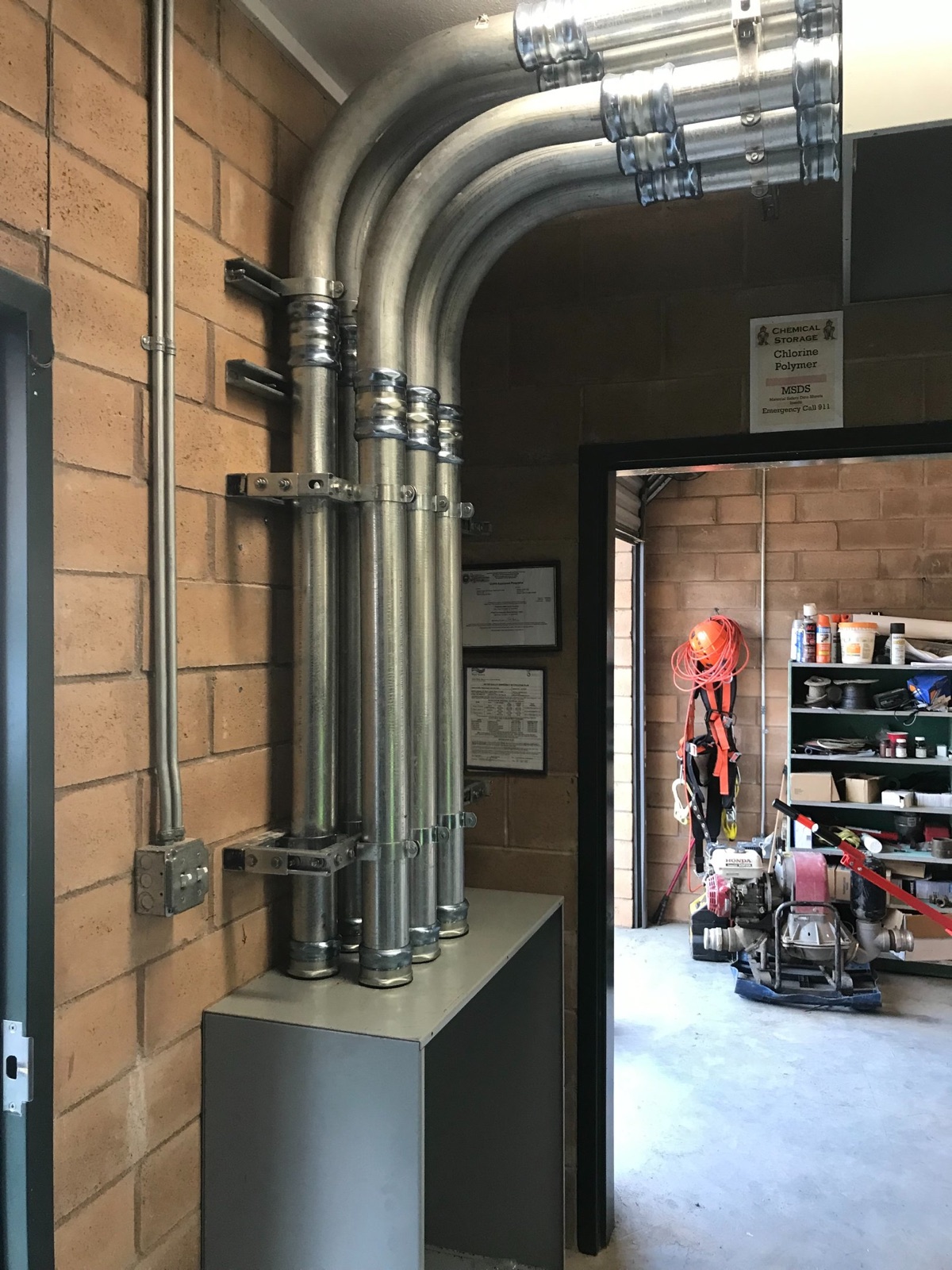 Finished conduit installation beside process equipment
