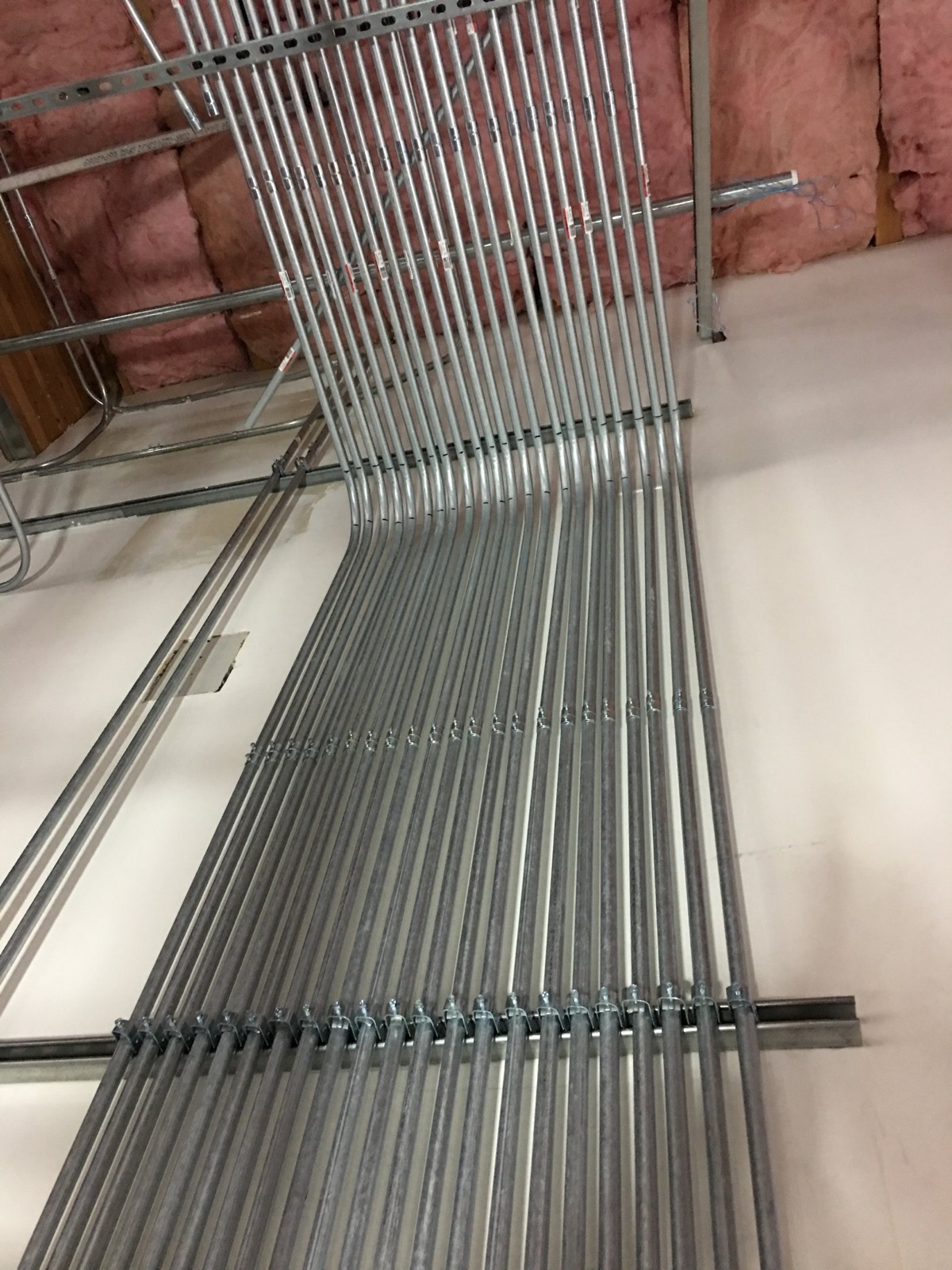 Precision overhead conduit routing