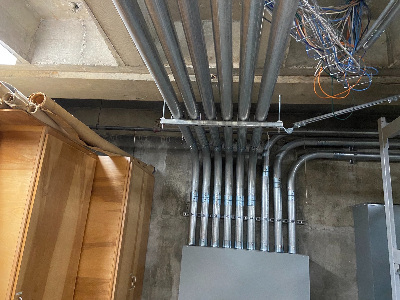 Overhead conduit entering a distribution cabinet