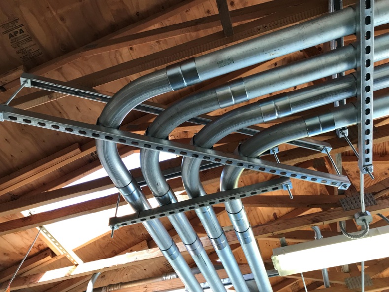 Overhead feeder conduit in a mechanical room
