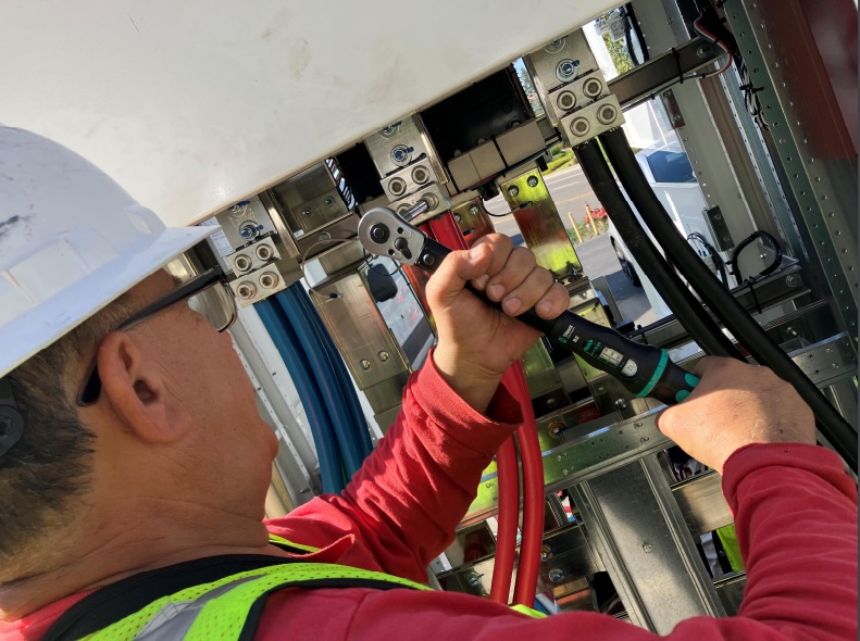 Electrician terminating large service conductors